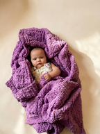 Baby wrapped in a soft, 100% handmade crochet baby blanket, providing warmth and comfort – the perfect personalized baby gift.