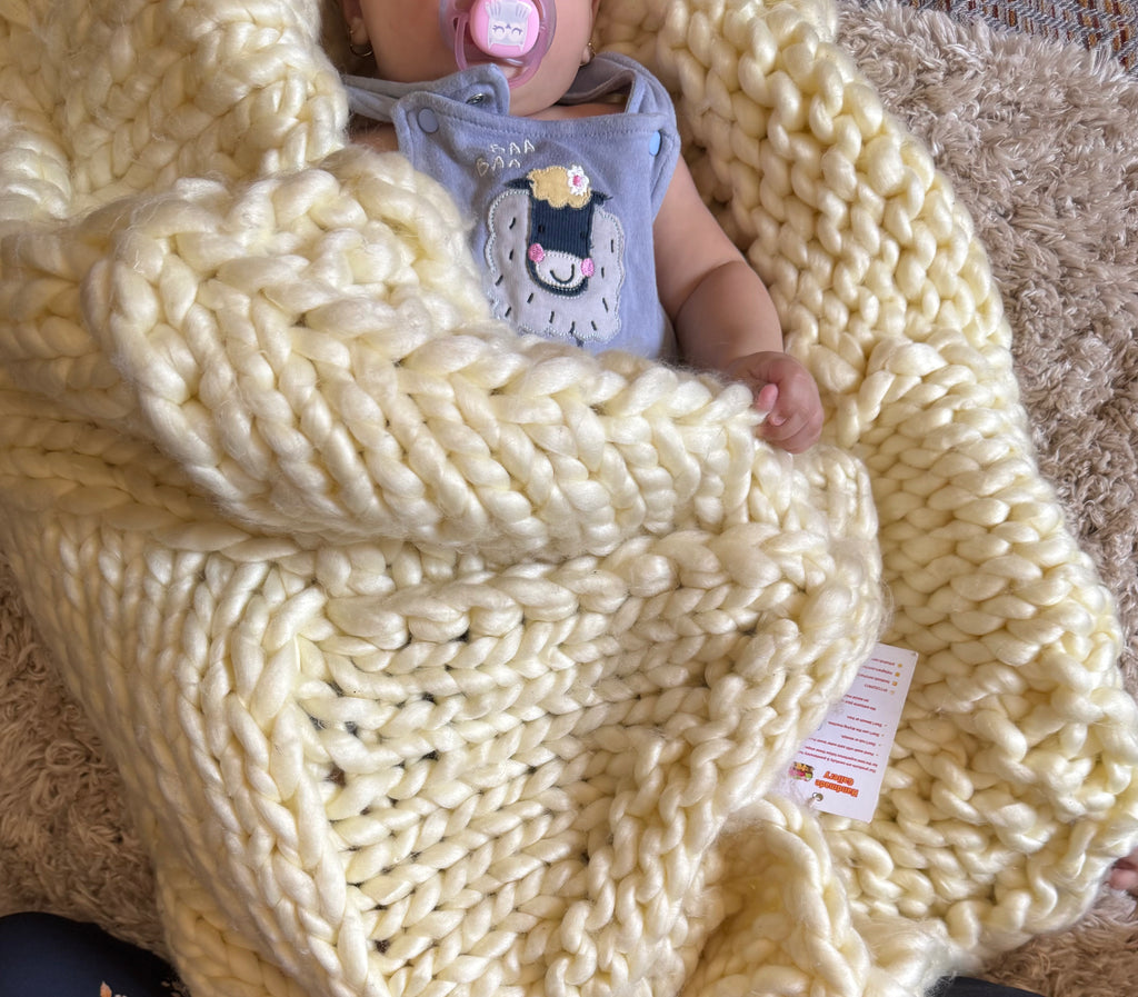 faia resting on a soft, 100% handmade crochet baby blanket, crafted from premium cotton – the perfect newborn baby gift to provide warmth and comfort
