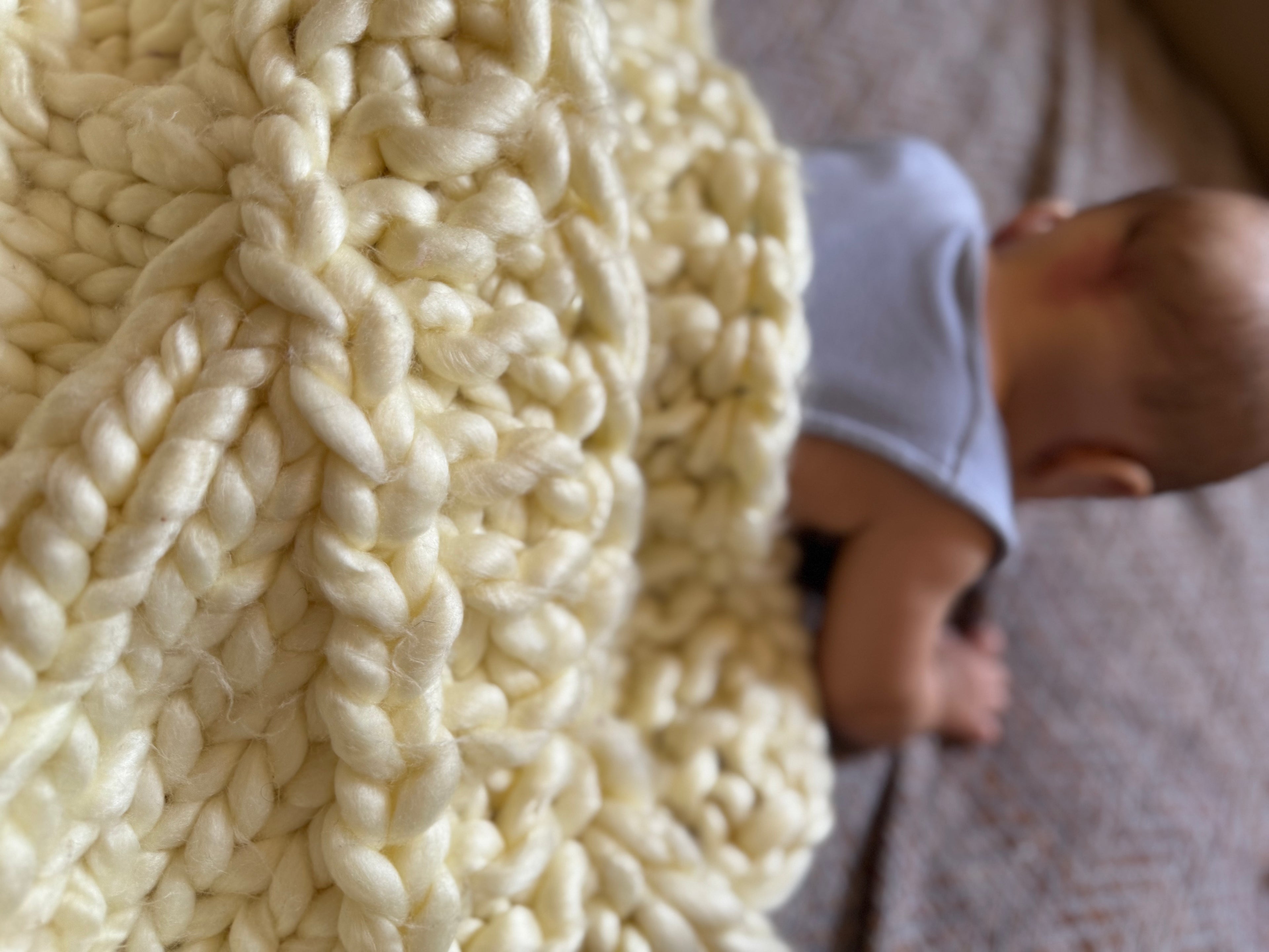 faia resting on a soft, 100% handmade crochet baby blanket, made from premium cotton – the perfect newborn baby gift that offers warmth and cozy comfort.