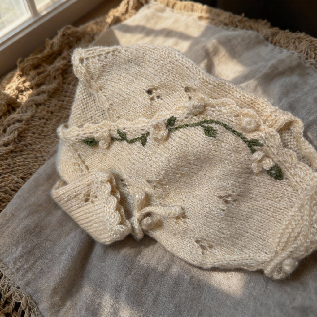 Luxurious handmade knit newborn clothes featuring delicate floral embroidery, made with premium cotton – the perfect newborn gift