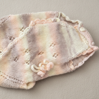 Close-up of luxurious handmade knit newborn clothes, crafted from premium Egyptian cotton – the perfect baby shower gift
